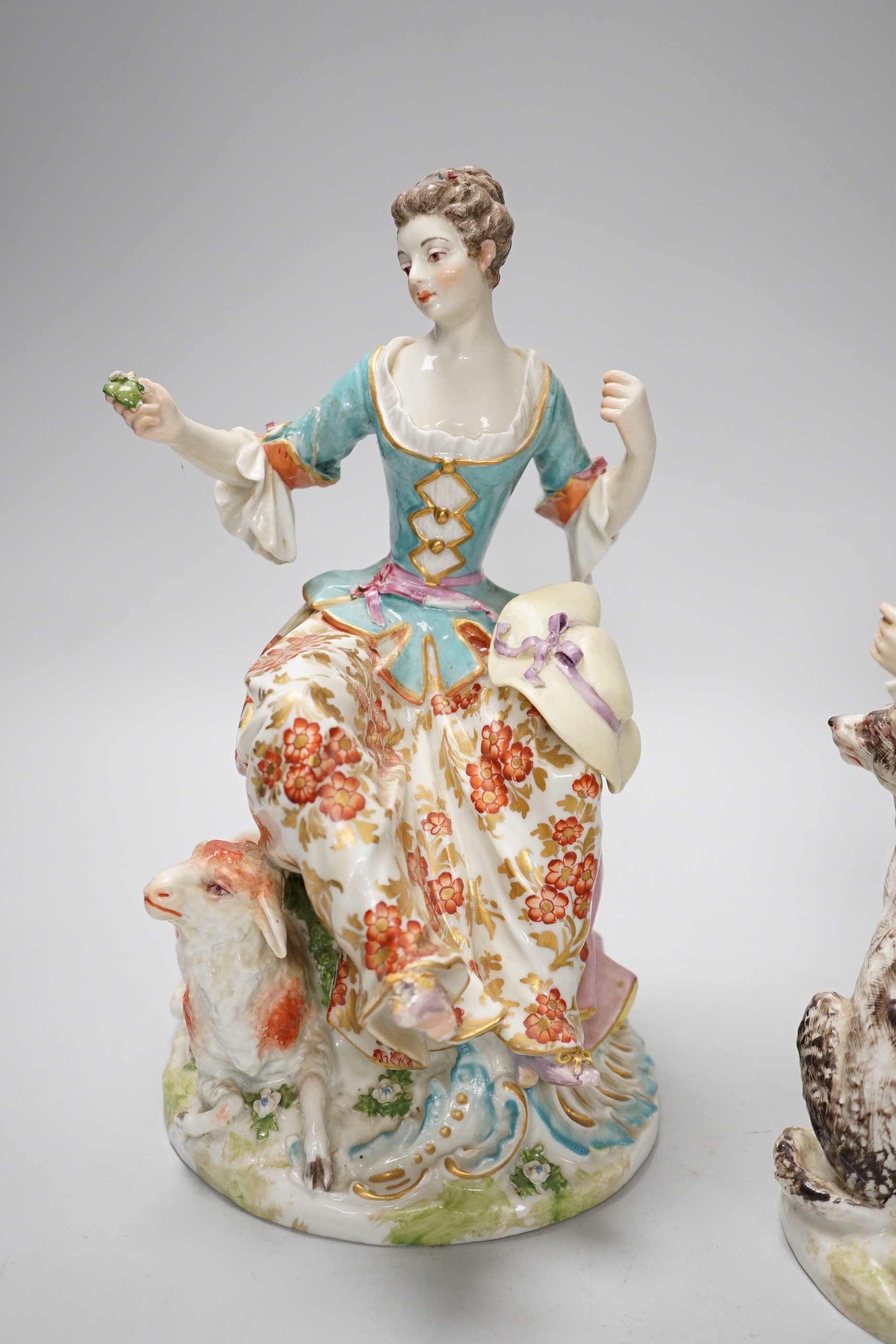 A pair of Chelsea Derby figures, seated male and female, 27.5cm